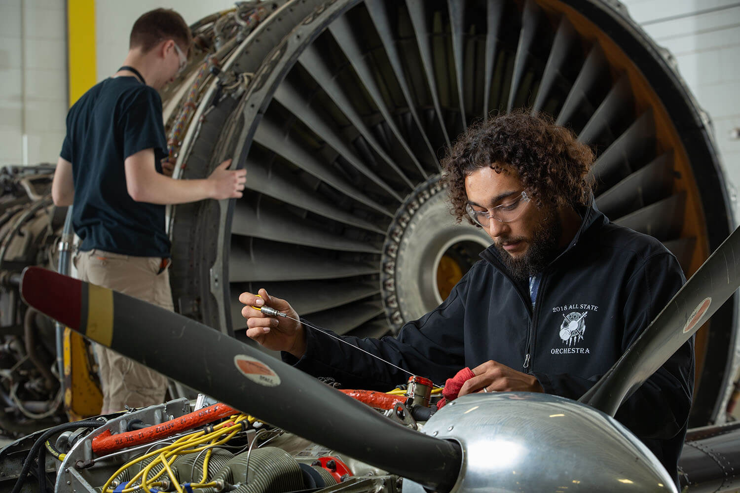 Mechanic working on airplane engine.